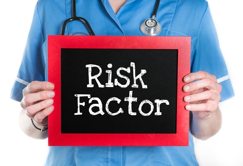 Doctor holding risk factor sign